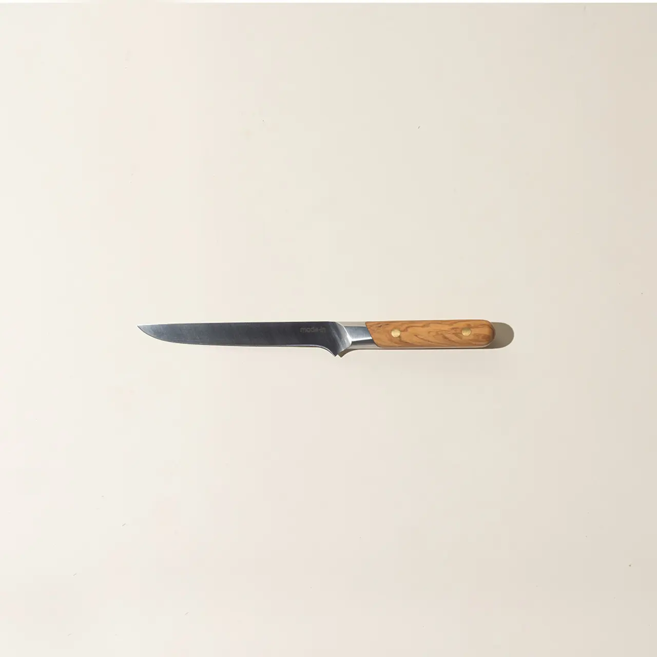 A kitchen knife with a wooden handle is centered against a plain background.