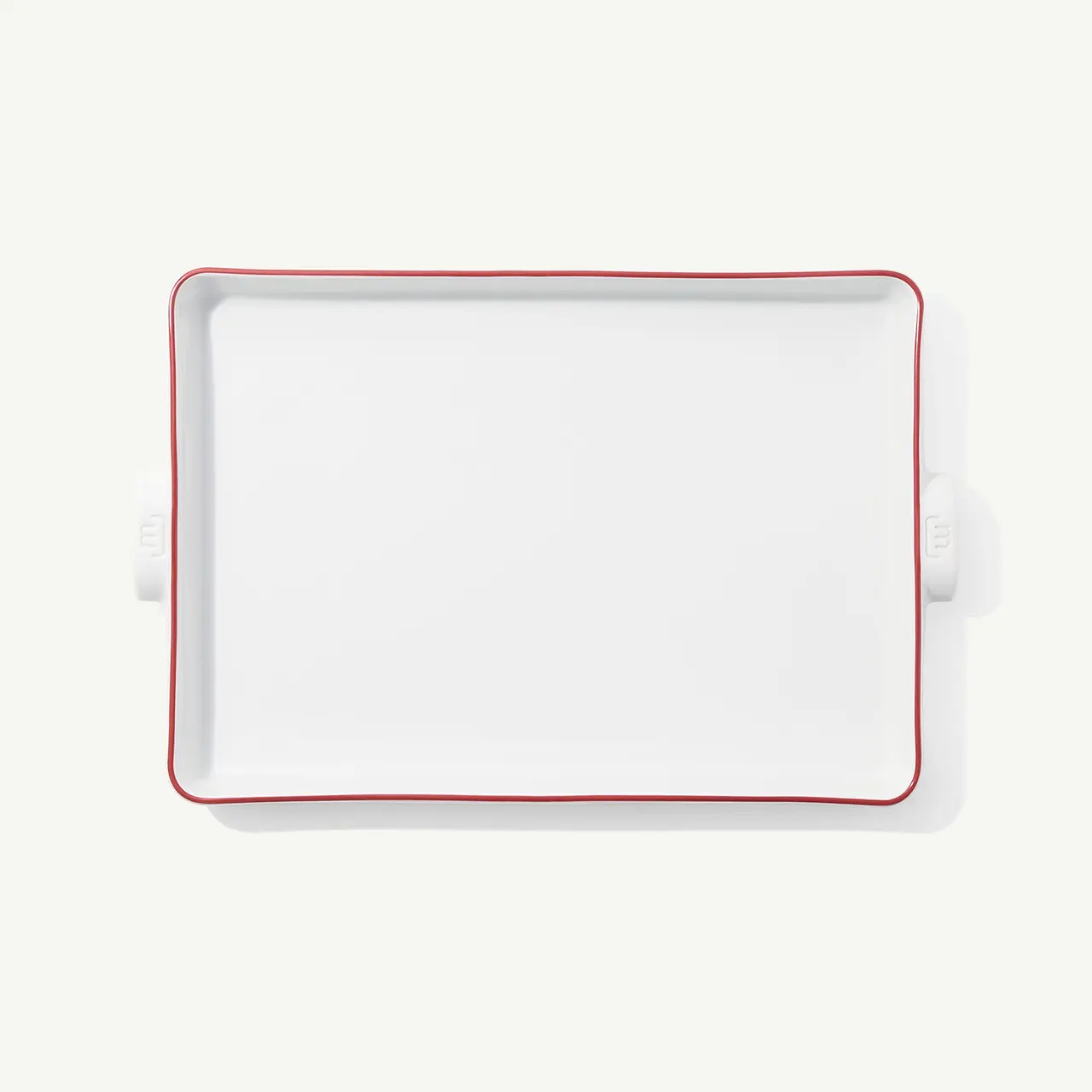 A plain white rectangular serving platter with a red trim is centered on a white background.