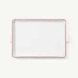 A plain white rectangular serving platter with a red trim is centered on a white background.