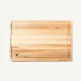 A wooden cutting board featuring a minimalist design with a logo in one corner.