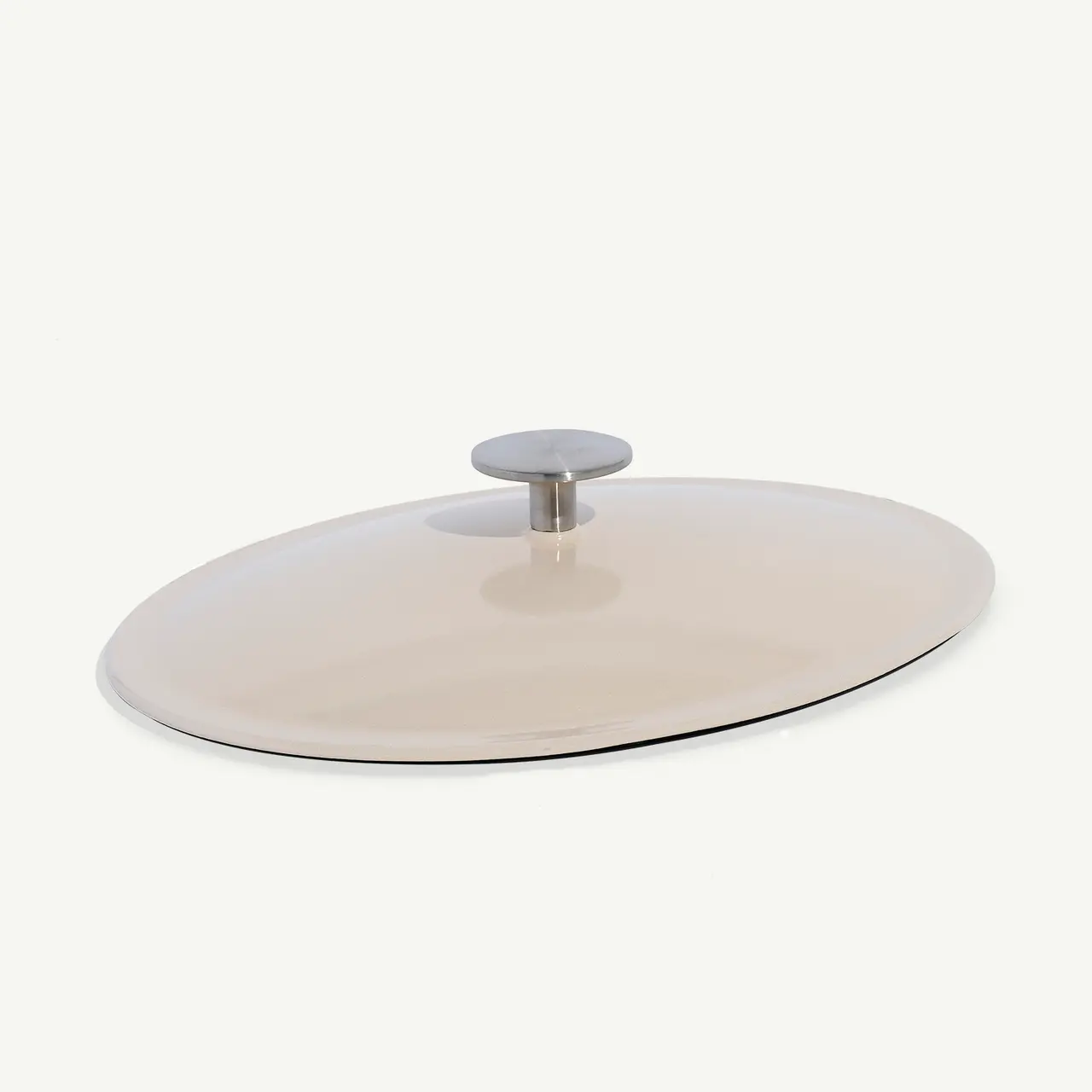 A round, flat ceramic lid with a silver-colored knob handle against a plain background.