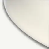 A curved edge of a plain white circular object is shown against a contrasting background.