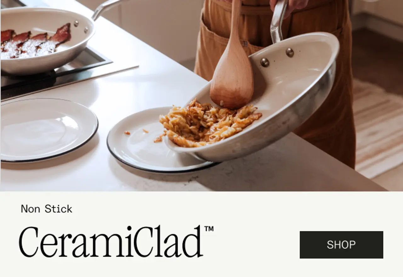 A person is using a spatula to serve food from a non-stick frying pan onto a plate in a kitchen setting.