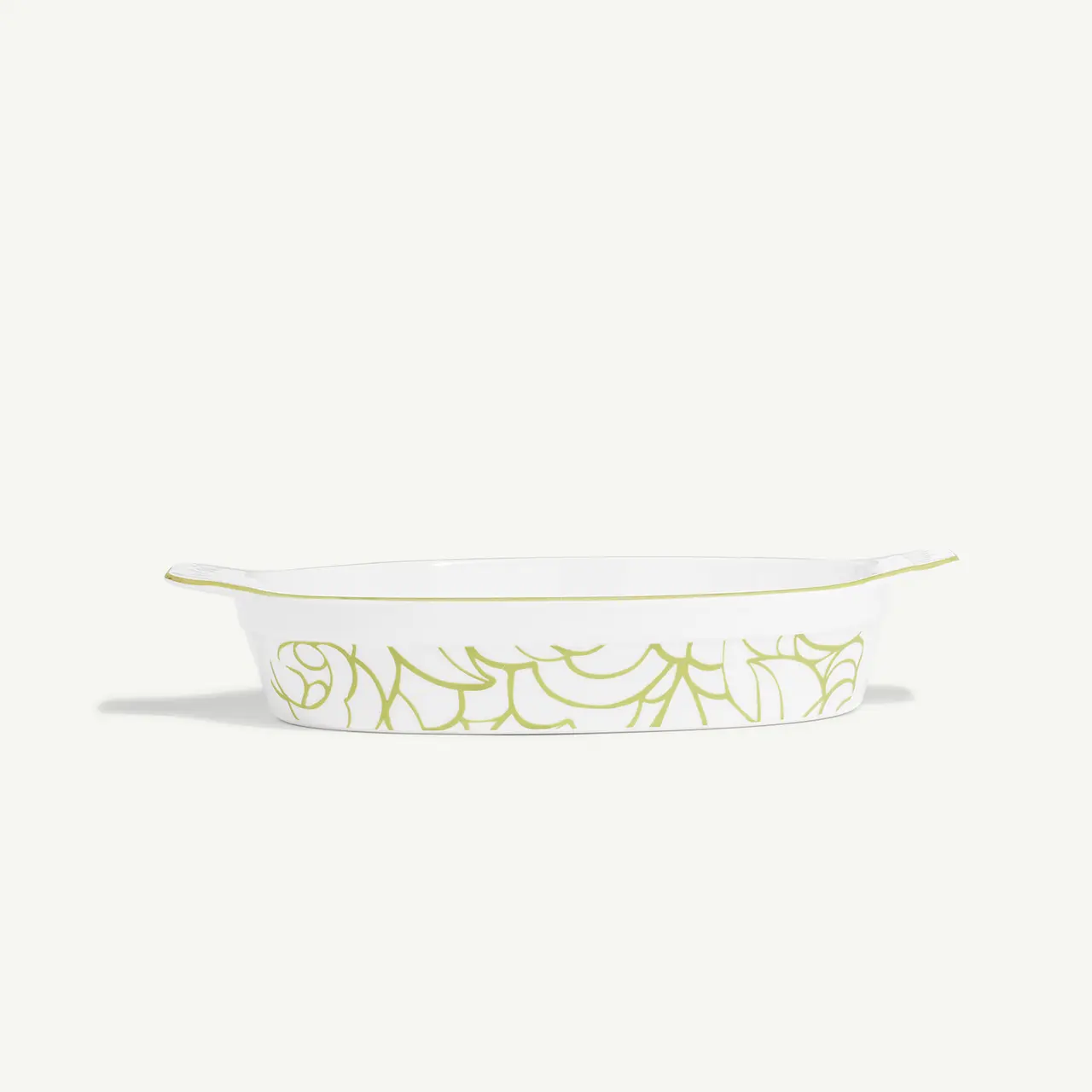 A white rectangular ceramic baking dish with green decorative patterns on the side and a yellow rim.