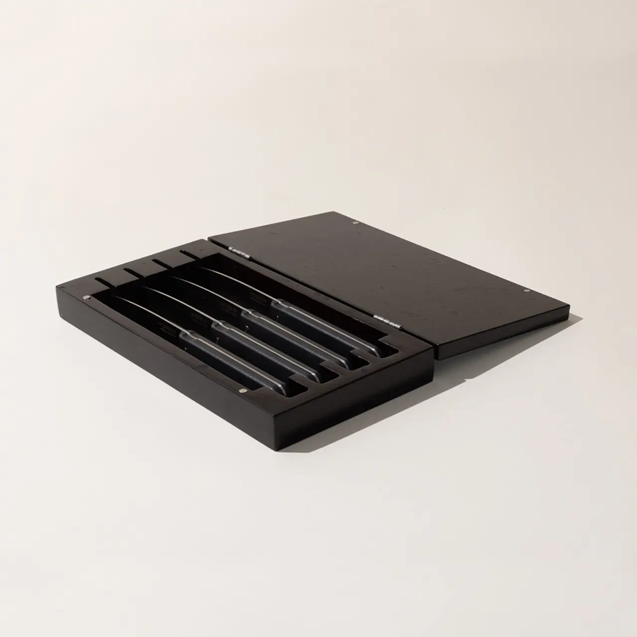 An elegant black box with a set of stylus pens inside, displayed against a plain background.
