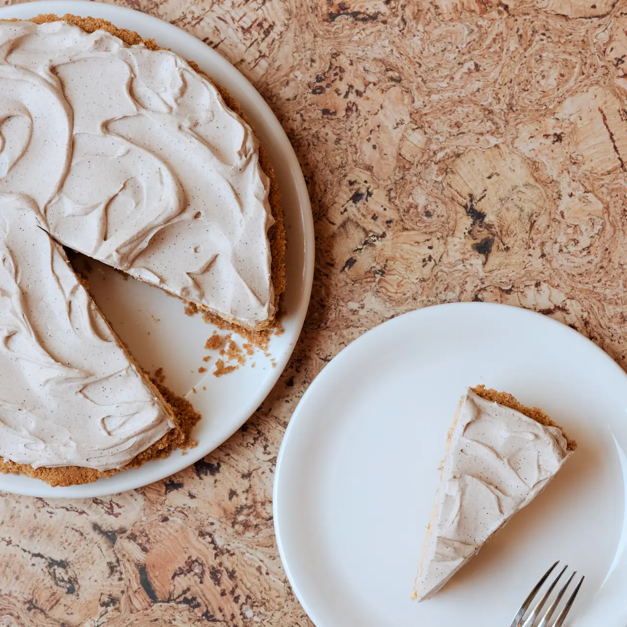 A whole pie with one slice served on a separate plate showcases a tempting dessert ready to be enjoyed.