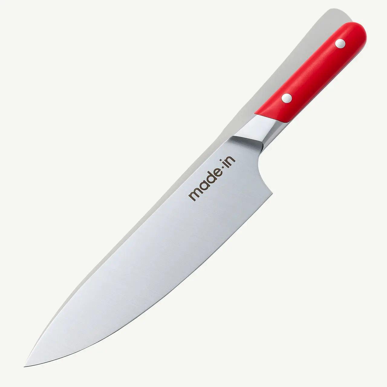 A chef's knife with a red handle and a silver blade that has the text "made in" imprinted on it, displayed against a white background.