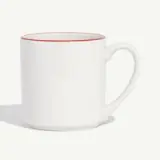 A white mug with a red rim on a light background.
