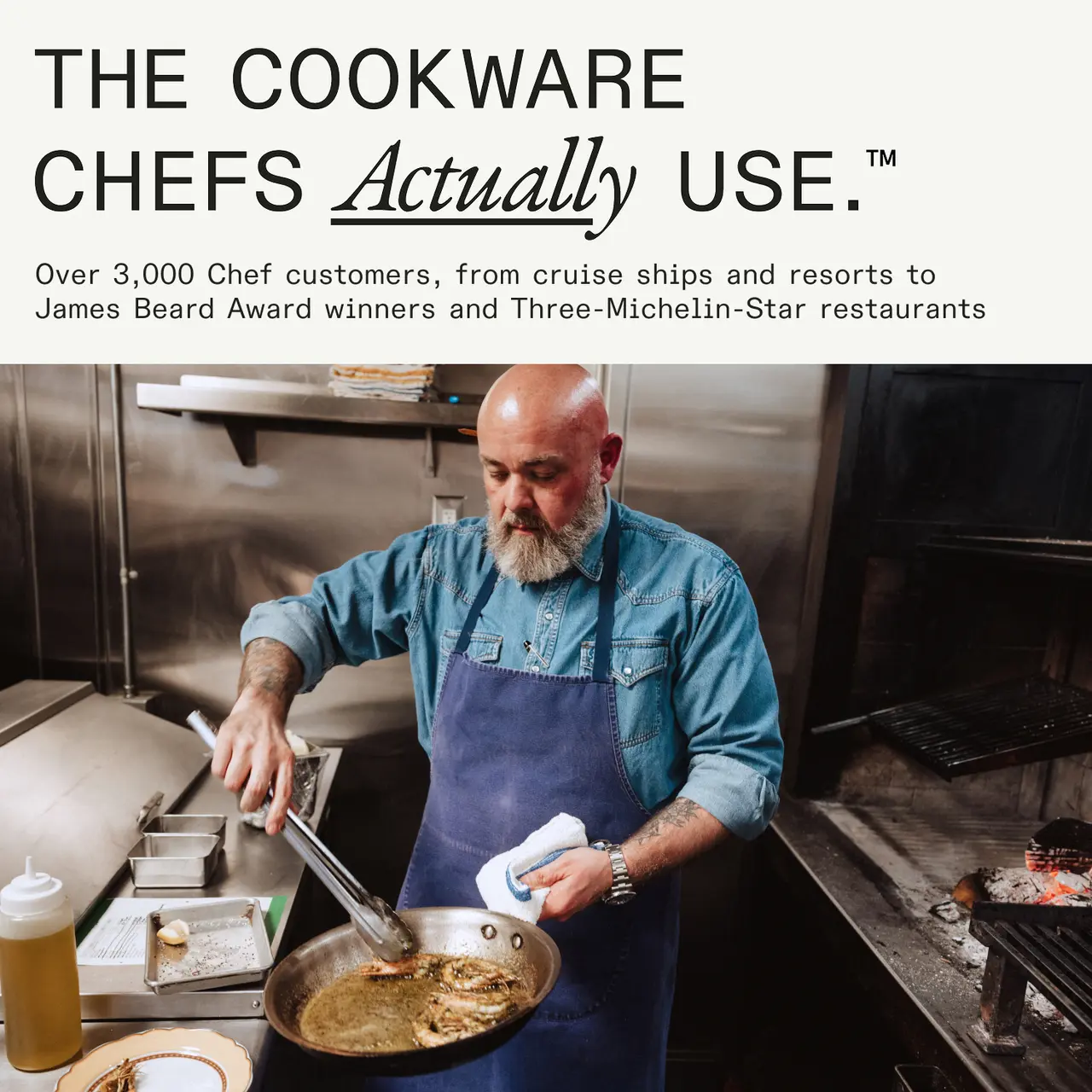 A chef with a beard prepares food in a commercial kitchen, highlighting cookware preferred by professional chefs.