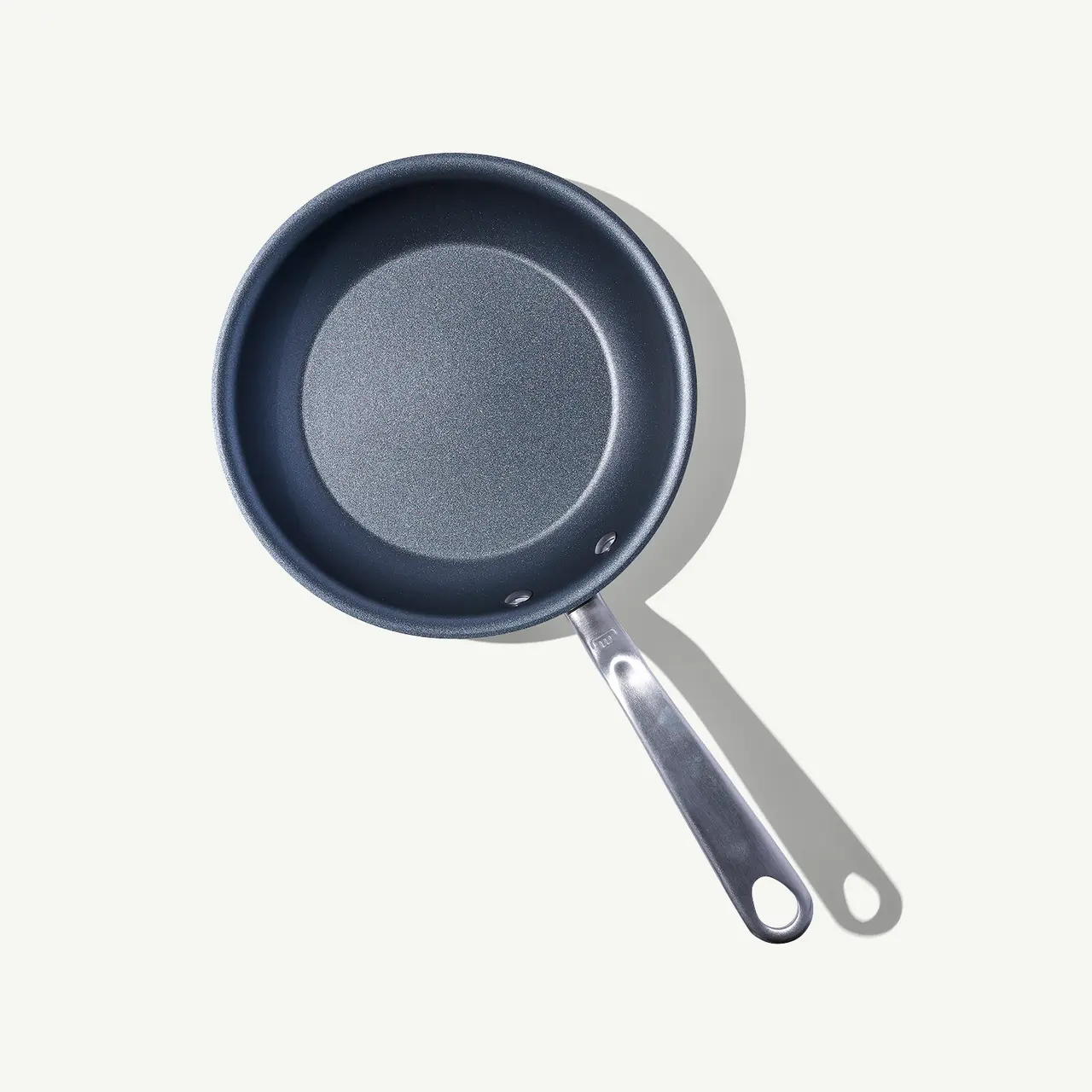 A non-stick frying pan with a silver handle, pictured against a light background.