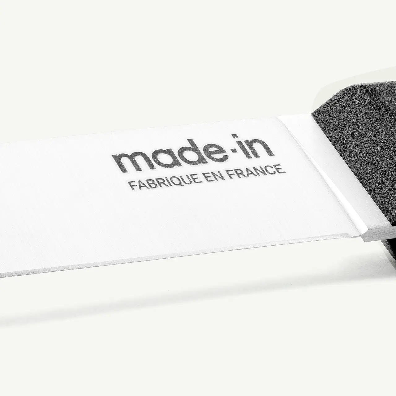 A clothing label reads "made in Fabrique en France" against a white background.