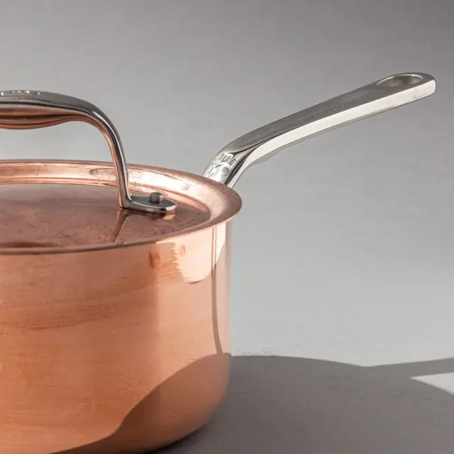 copper saucepan on a grey background