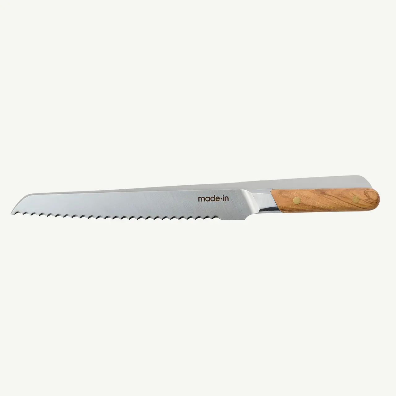 A serrated bread knife with a stainless steel blade and wooden handle isolated on a white background.