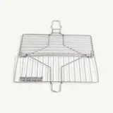 A stainless steel fish grilling basket lies against a white background.