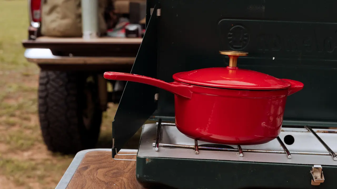 enameled cast iron saucepan on camping stove