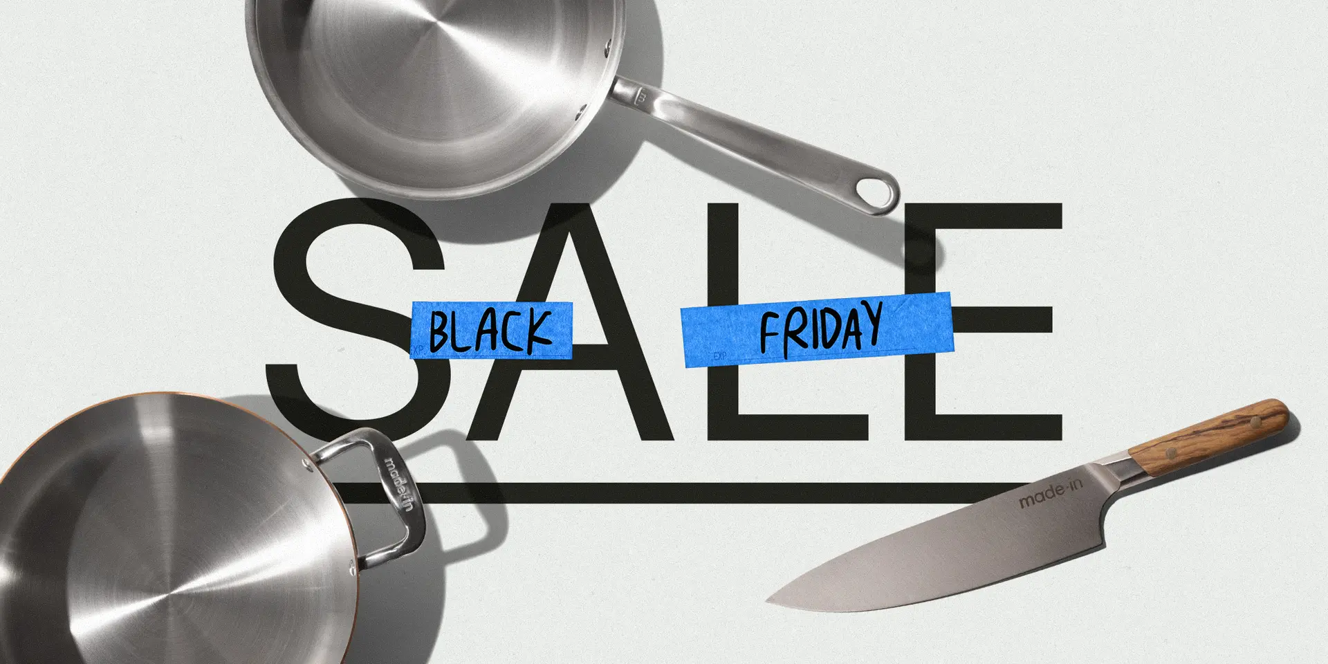 An advertising image showing two stainless steel pans and a chef's knife with the words "SALE BLACK FRIDAY" where "BLACK" and "FRIDAY" are covered by blue tape, suggesting a Black Friday sale on kitchenware.