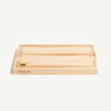 A wooden cutting board with a smooth surface and engraved branding, designed for food preparation.