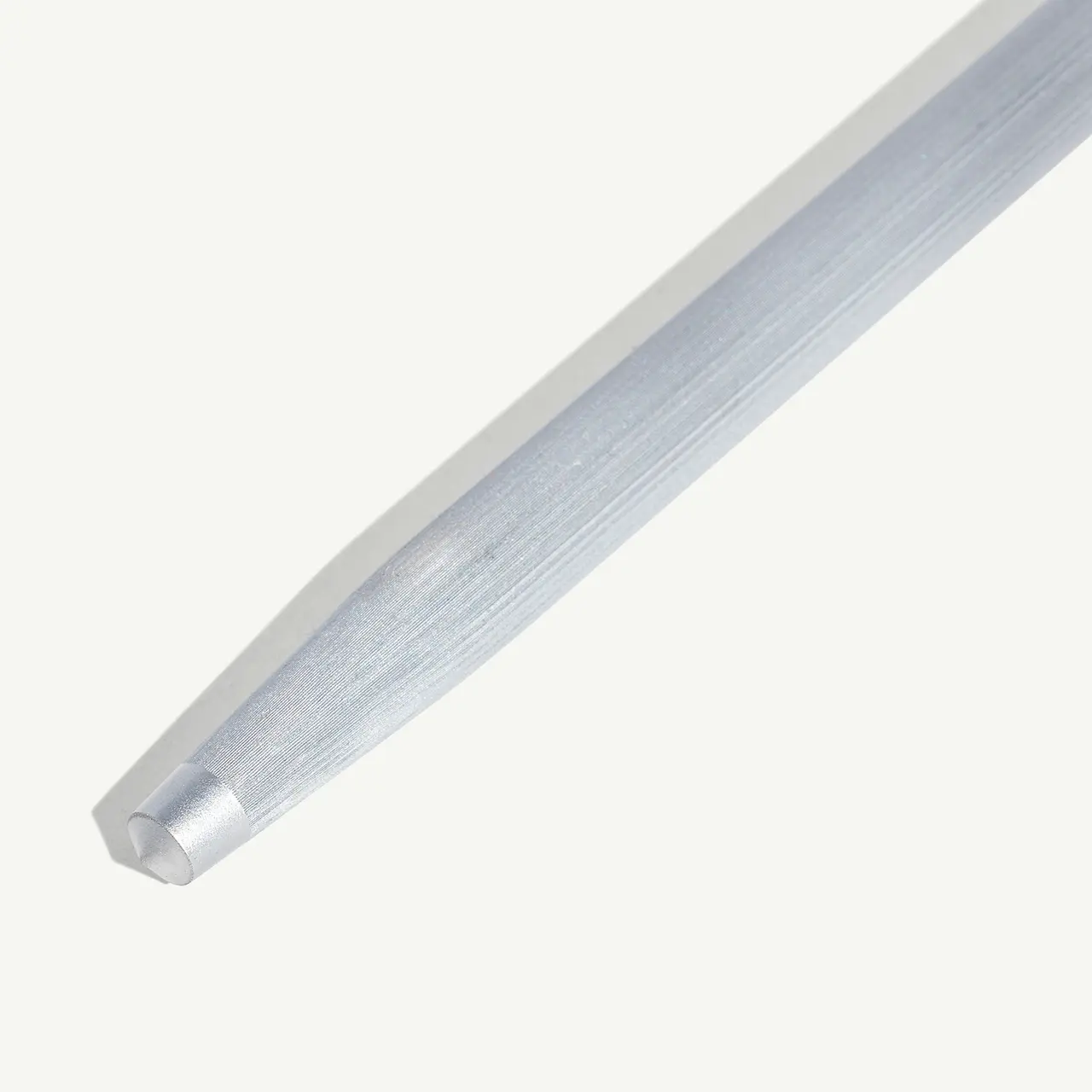 A close-up of a metallic rod against a plain background, slightly diagonal across the frame.