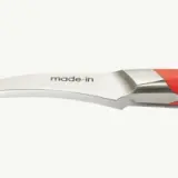 A close-up of a stainless steel utensil handle with the text "made in" imprinted on it, against a white background.