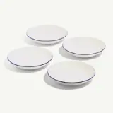 Three white plates with blue rims are arranged on a light background.