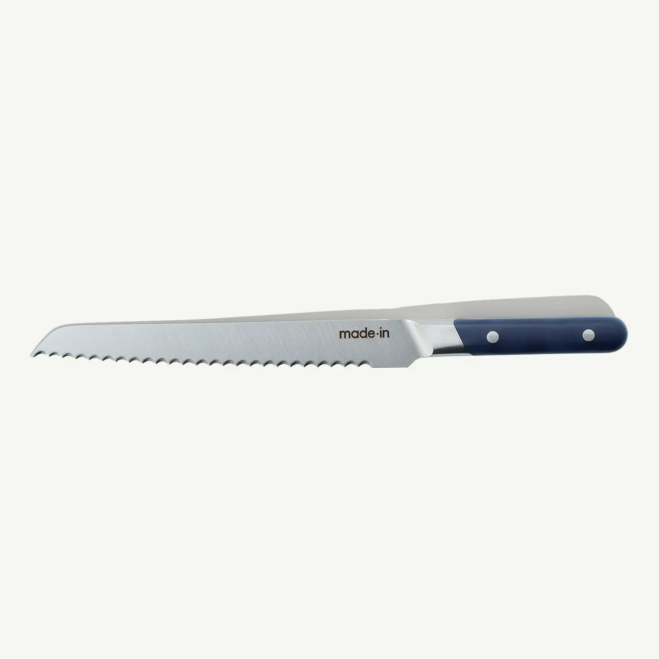 A serrated bread knife with a blue and black handle on a white background.