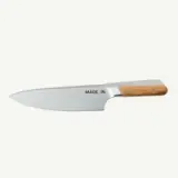A stainless steel chef's knife with a wooden handle features the text "MADE IN" on the blade.