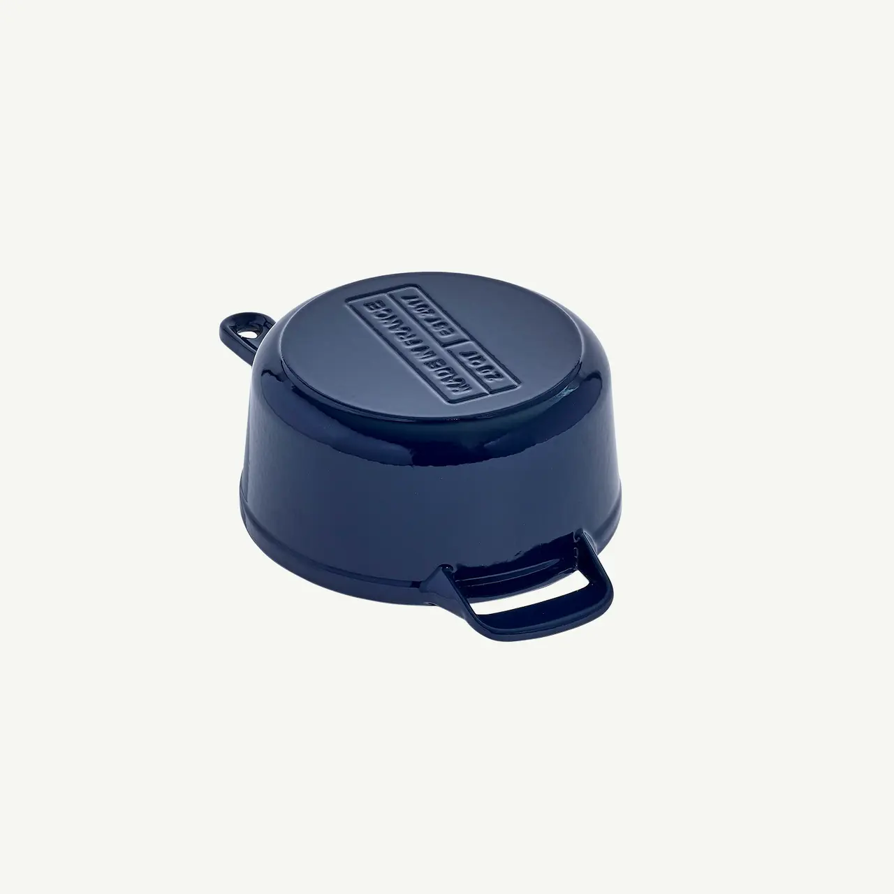 A navy blue saucepan with a lid and handles appears against a white background.