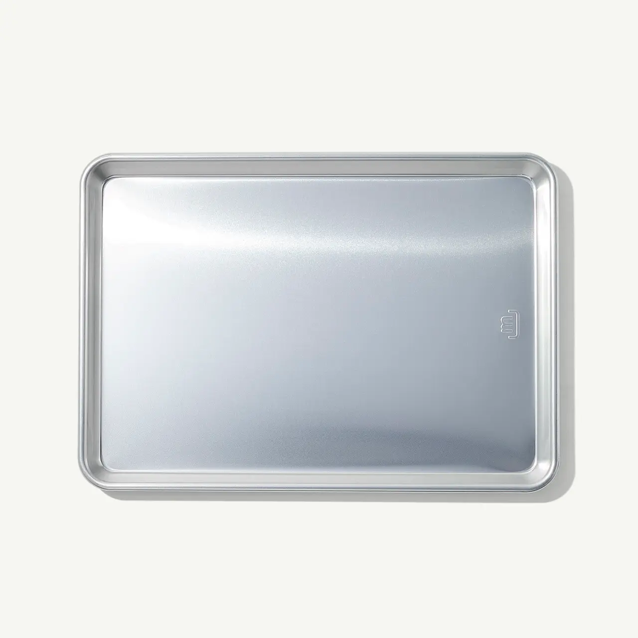 A stainless steel tray with rounded corners on a light background.
