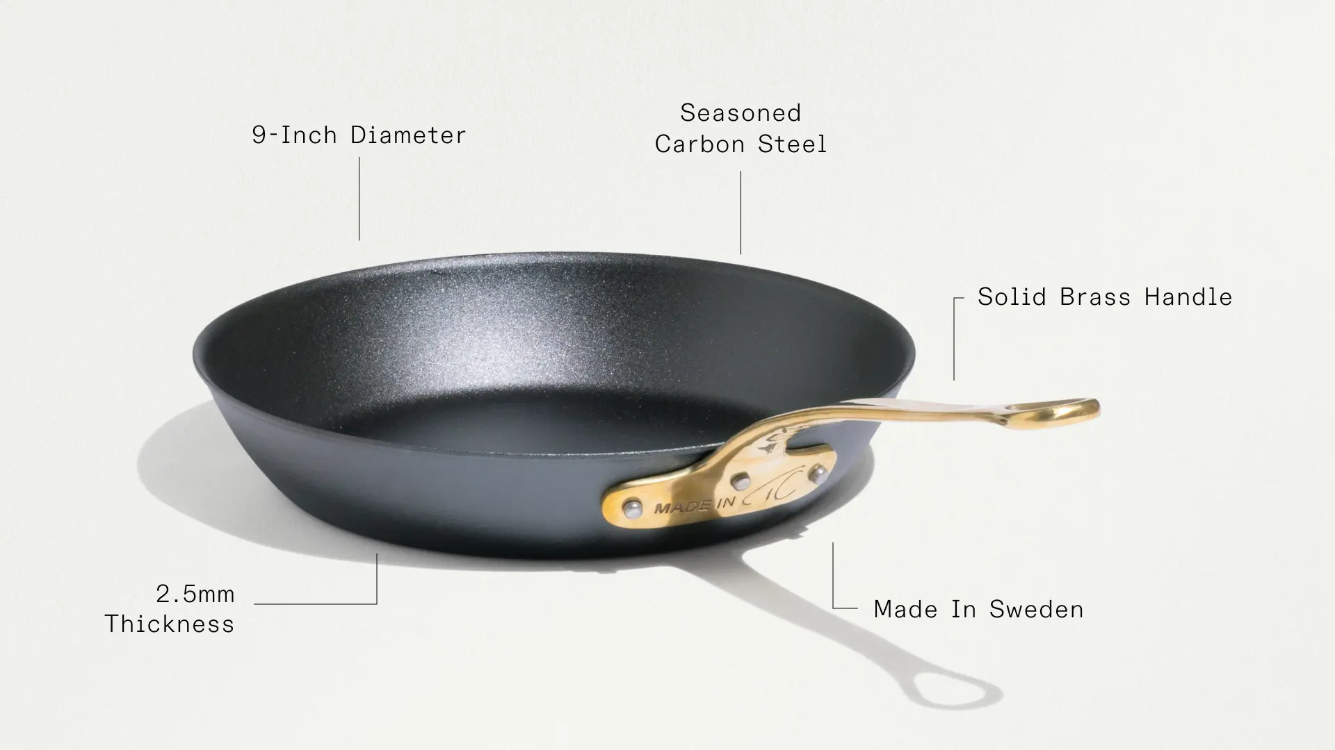 A 9-inch seasoned carbon steel frying pan with a solid brass handle and a thickness of 2.5mm, made in Sweden.