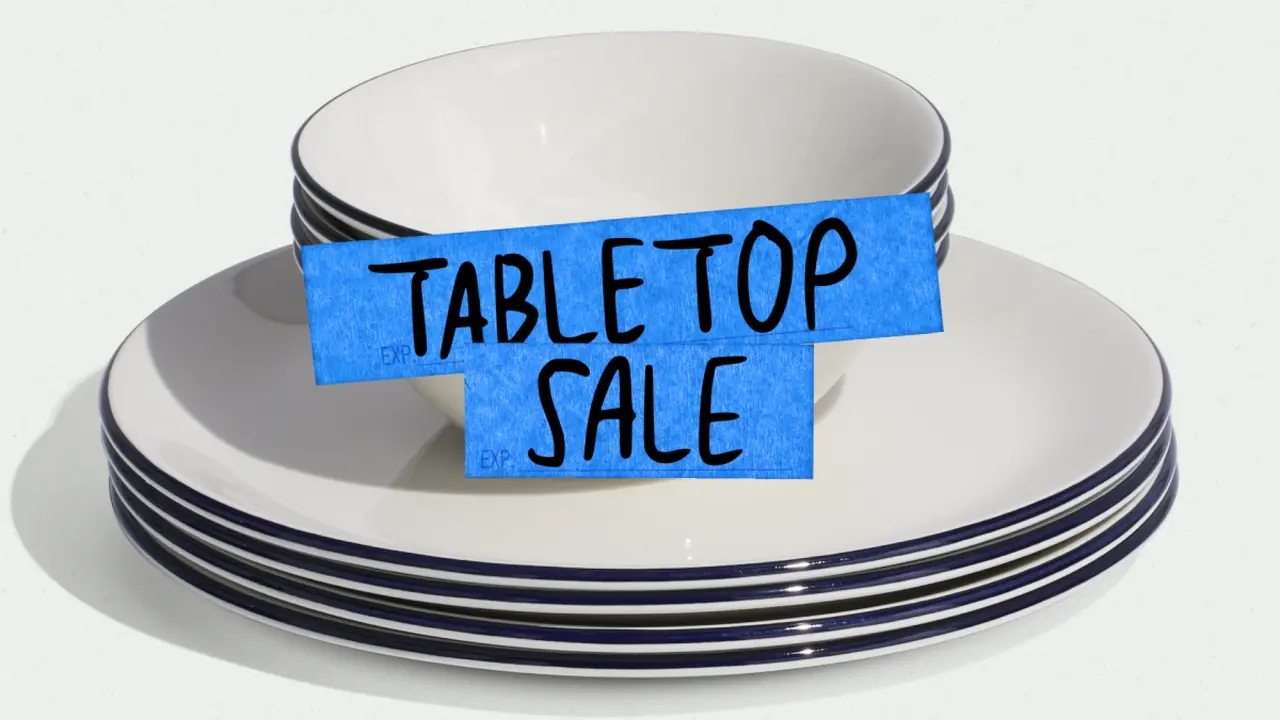 A stack of white plates with blue rims is labeled with a blue "TABLETOP SALE" sign.