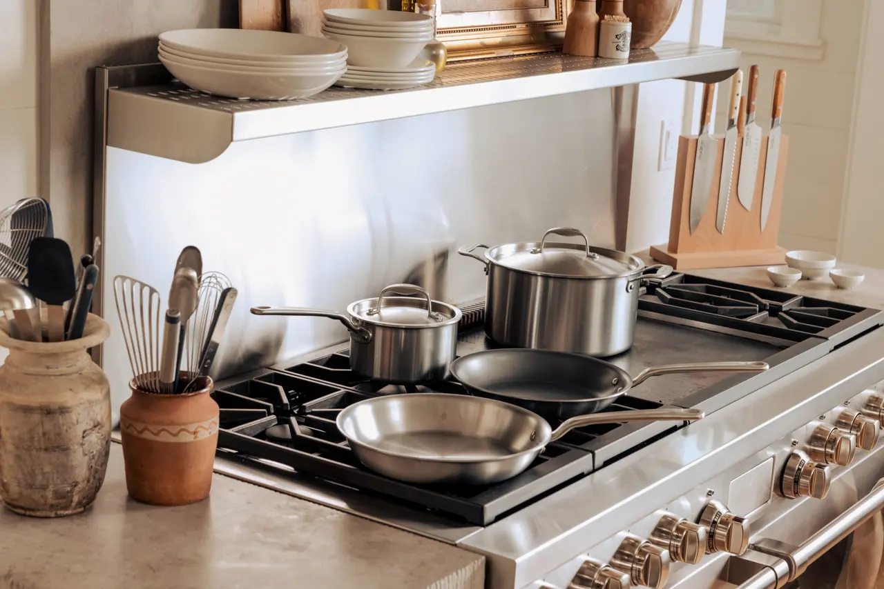 A well-organized kitchen countertop with a variety of cookware and utensils on display.