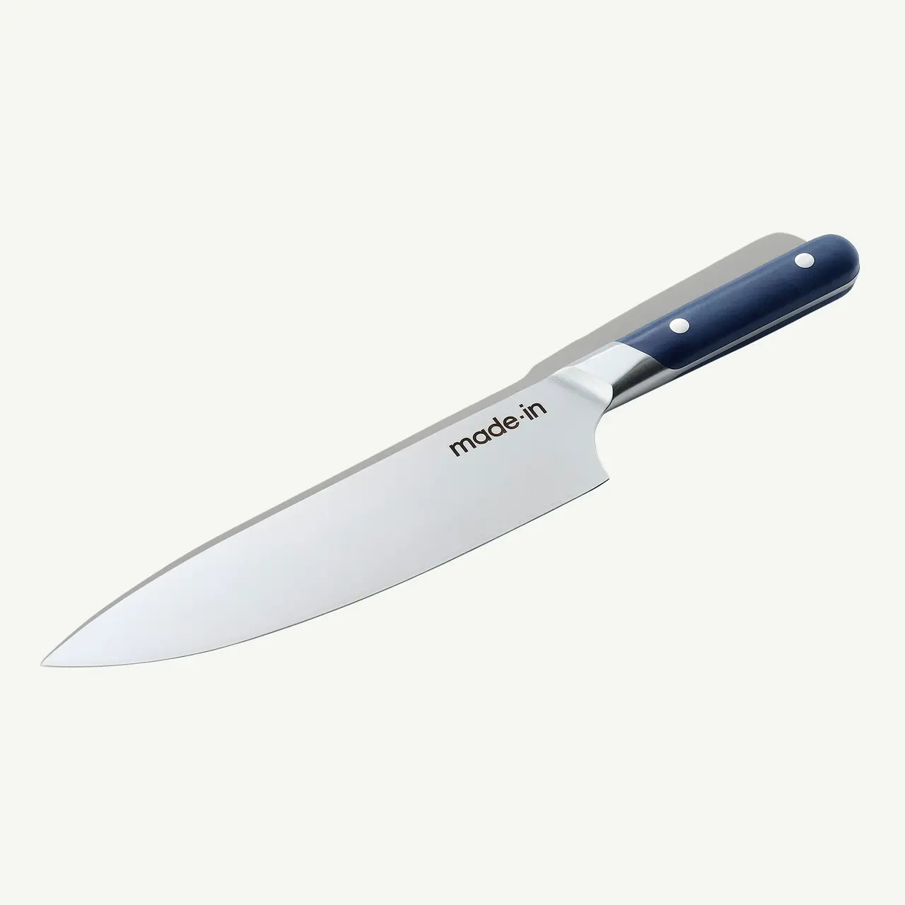A stainless steel chef's knife with a black handle is displayed against a white background.