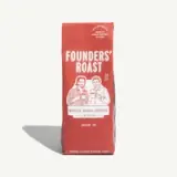 A red bag of whole bean coffee labeled "Founders' Roast," featuring illustrations of two men and the text "Limited Run" and "Made in Austin, Texas."