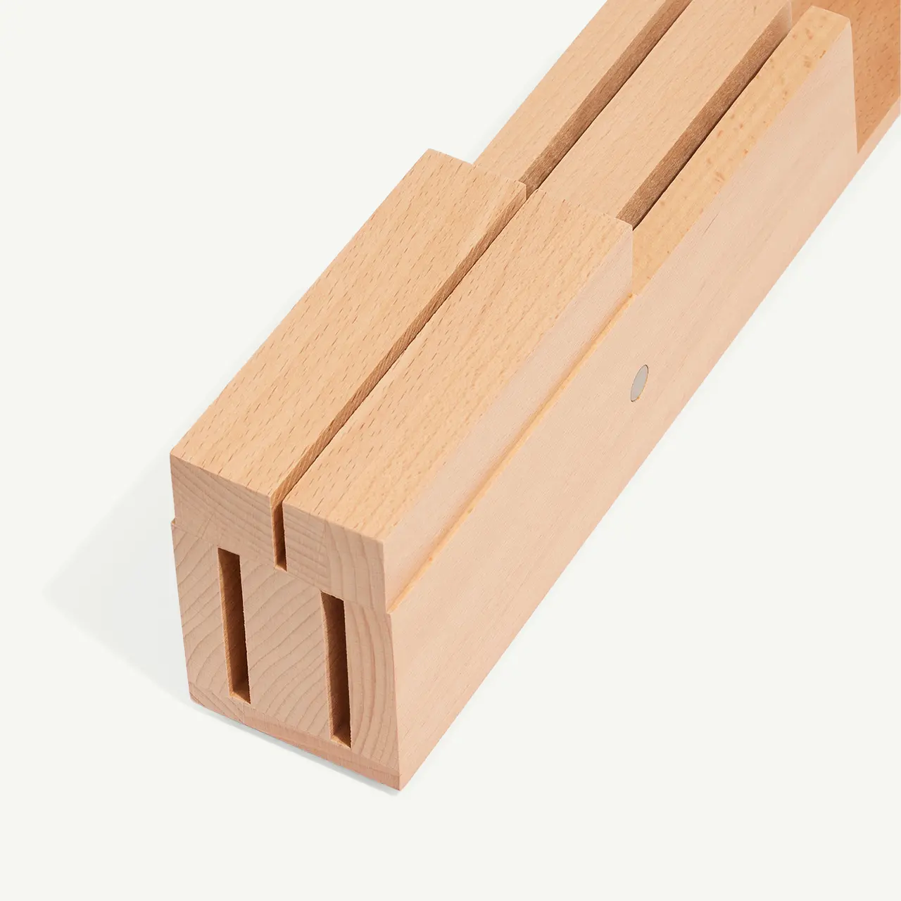 A wooden clothespin is isolated against a white background, showcasing its simple mechanical design.