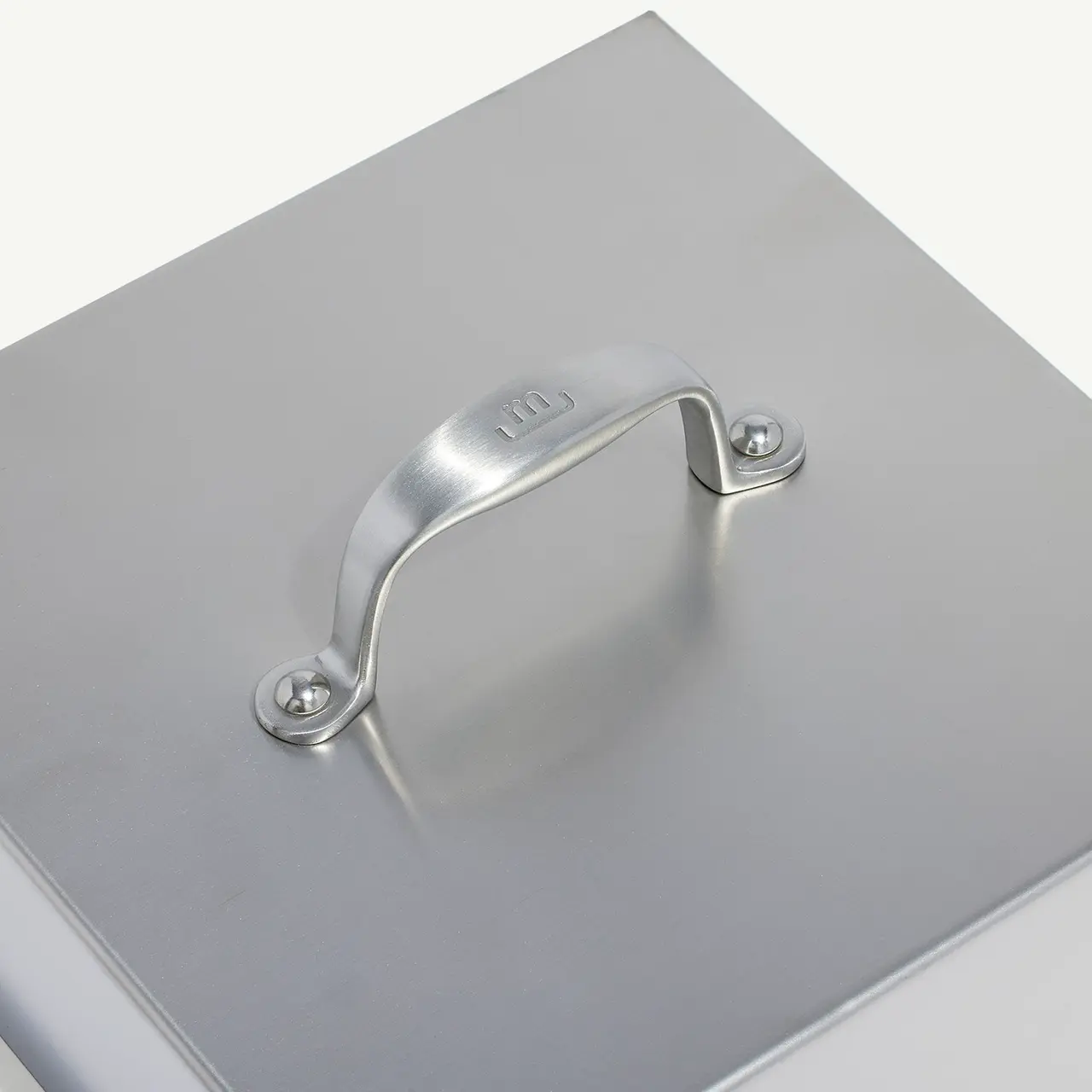 A silver metal case with a handle on top, presented against a white background.