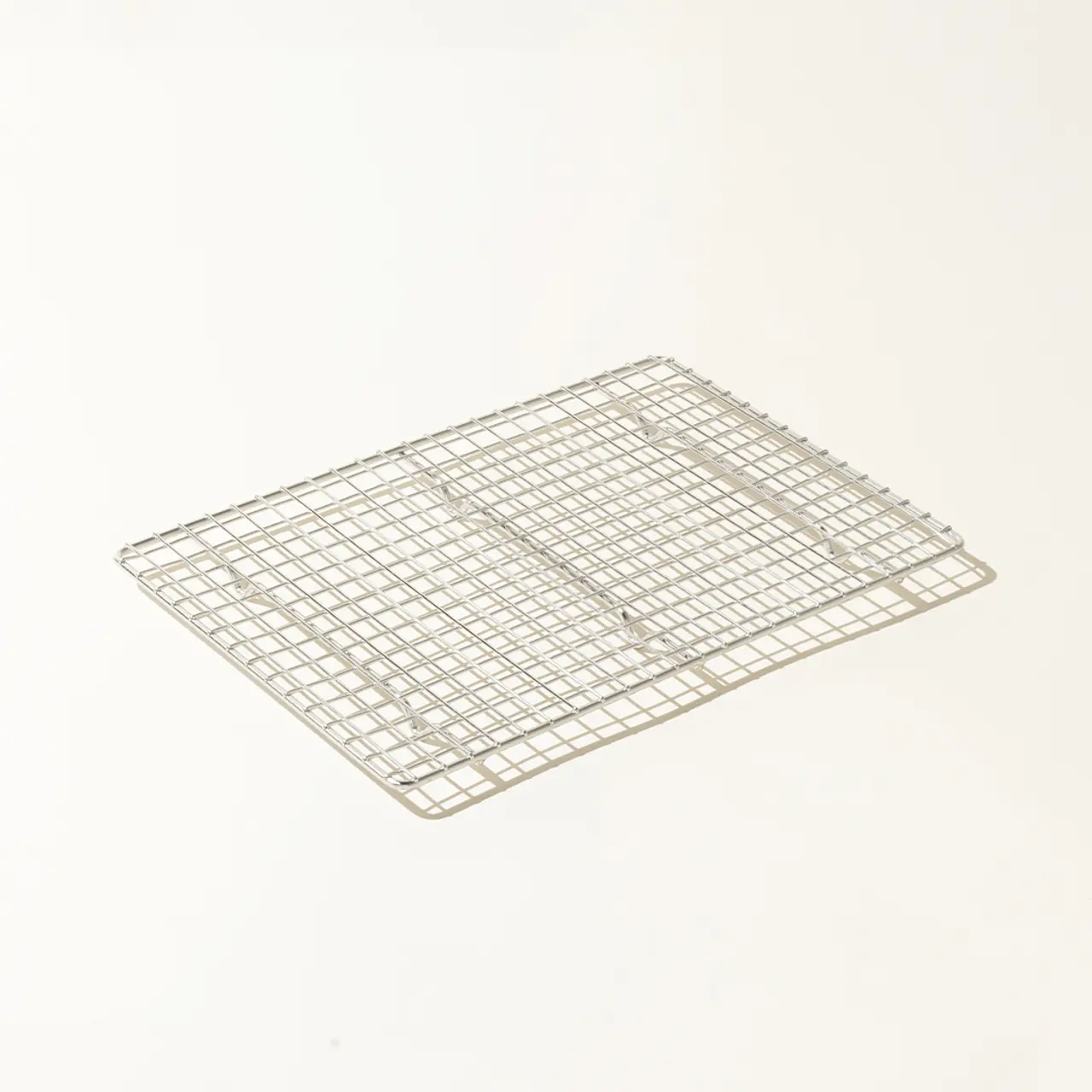 A metal cooling rack sits on a plain light-colored background.