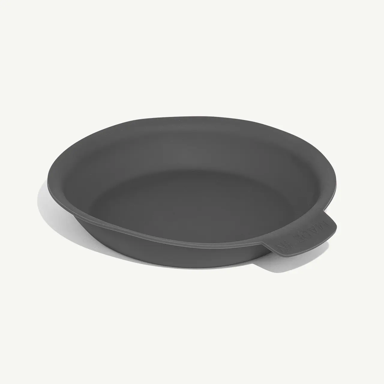 A plain gray round baking dish is displayed on a white background.