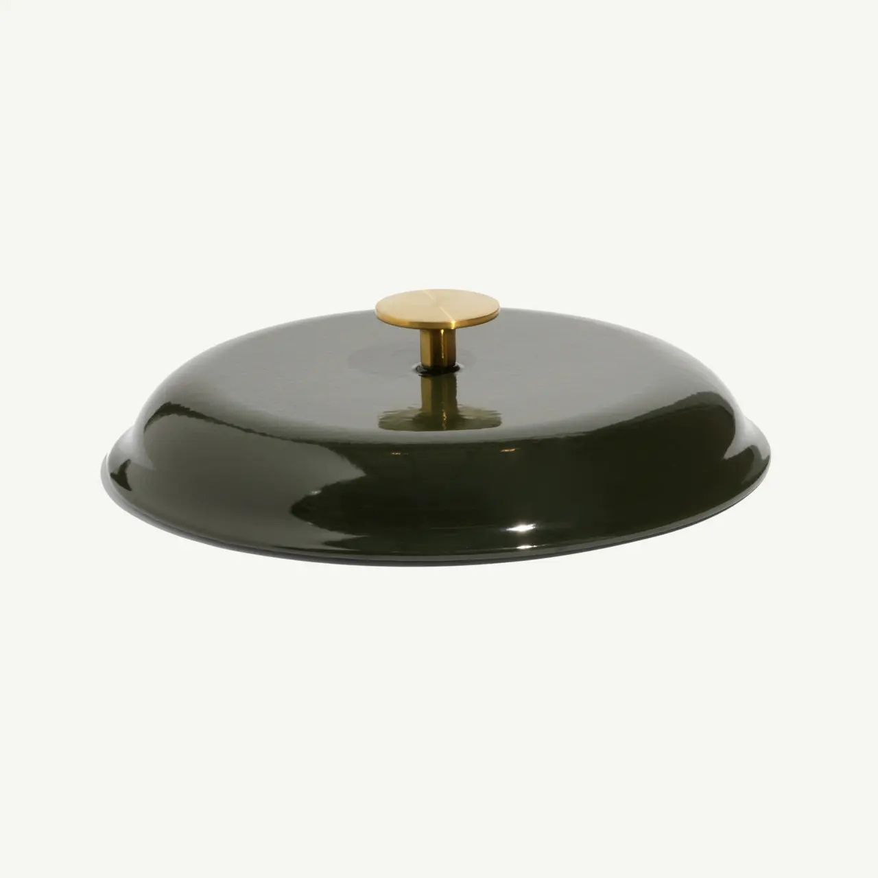 A round, glossy green lid with a gold handle sits on a plain background.