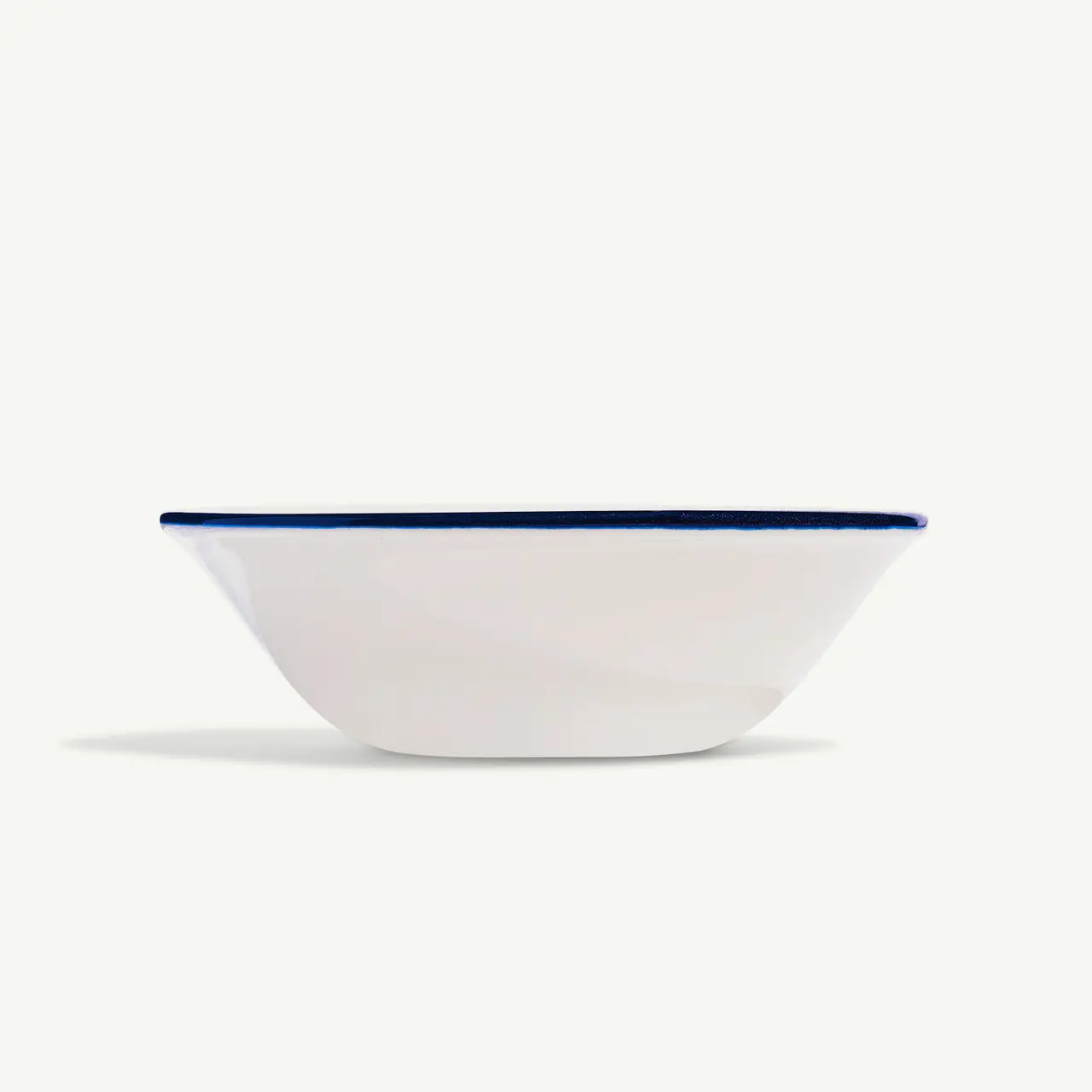 A simple white bowl with a blue rim on a plain background.