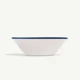 A simple white bowl with a blue rim on a plain background.
