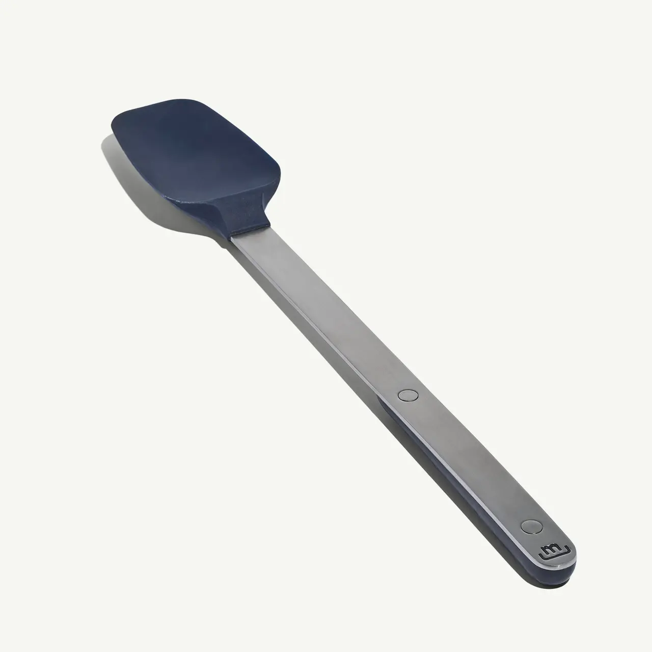 A silicone spatula with a stainless steel handle is displayed against a light background.
