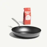 A black frying pan sits next to a red and white bag of coffee labeled "Founders' Roast."