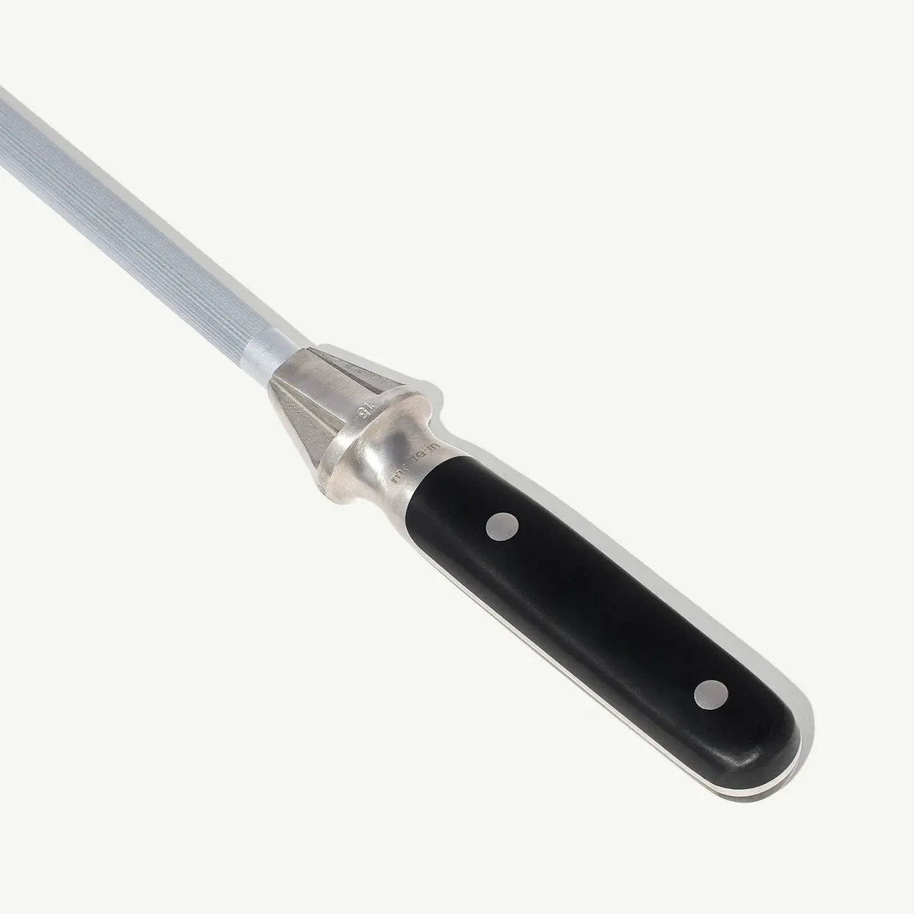 A close-up of a flat-head screwdriver with a black handle against a gray background.