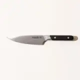 A stainless steel kitchen knife with a black handle, labeled "made.in," against a plain white background.