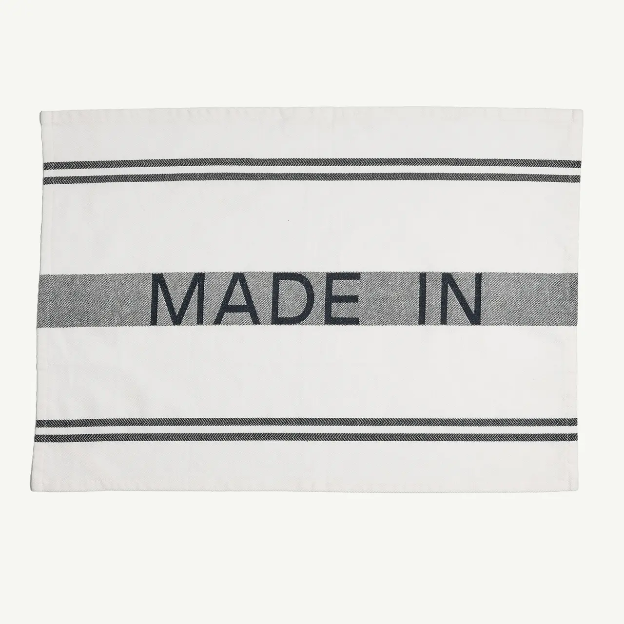 A label with the text "MADE IN" printed on it, awaiting completion with a country of origin.