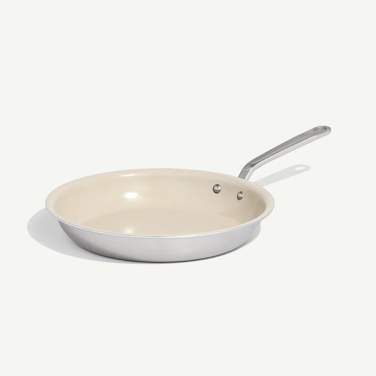 A non-stick frying pan with a silver handle is displayed against a plain background.