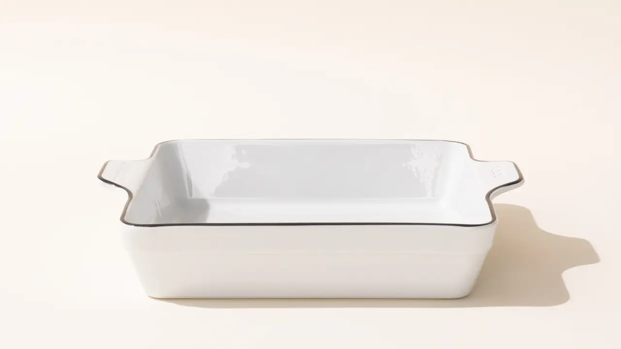 A white ceramic baking dish is centered on a light-colored background.