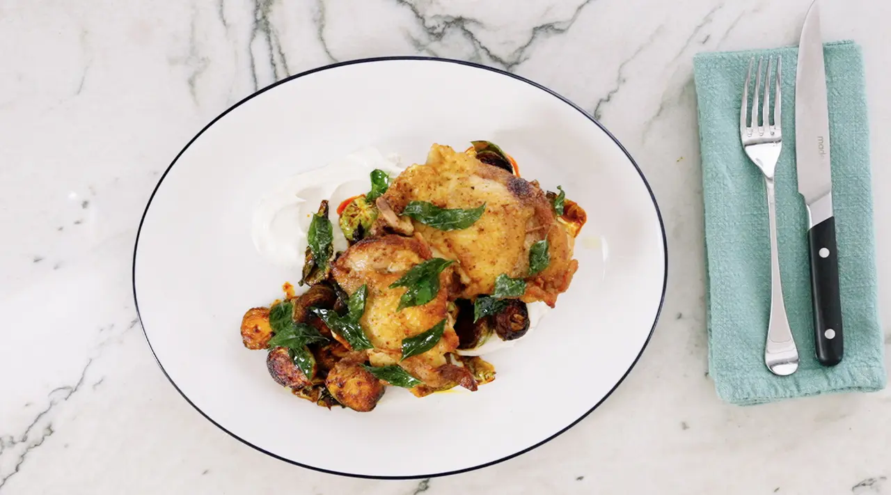 Crispy Chicken Thighs with Tahini Yogurt and Harissa Brussel Sprouts