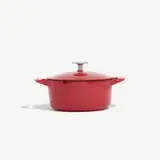 A red cooking pot with a lid centered against a white background.
