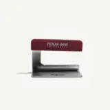 A maroon and silver stapler featuring the text "Texas A&M University."